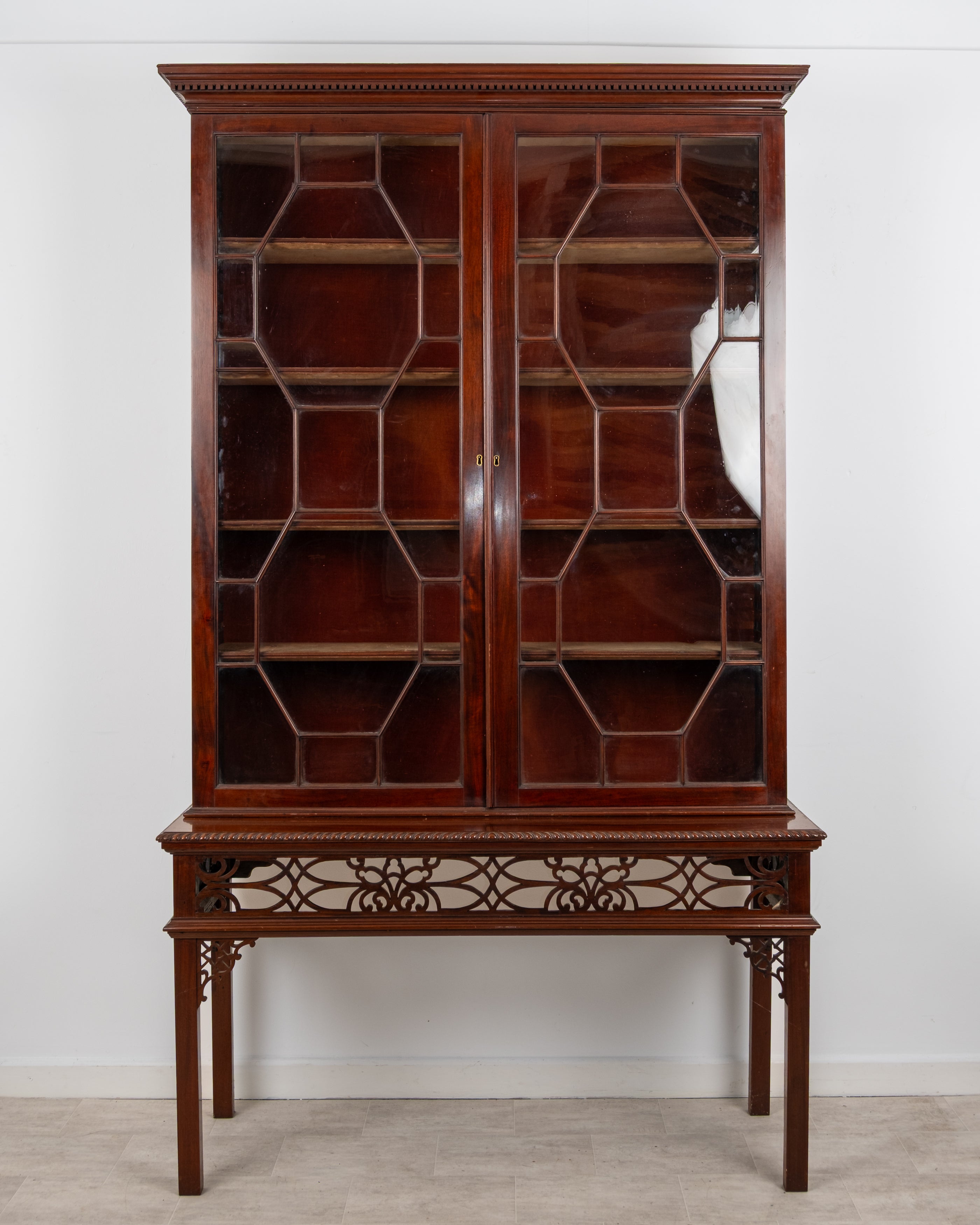 Antique carved mahogany astragal glazed bookcase on stand with open fretwork base c.1880