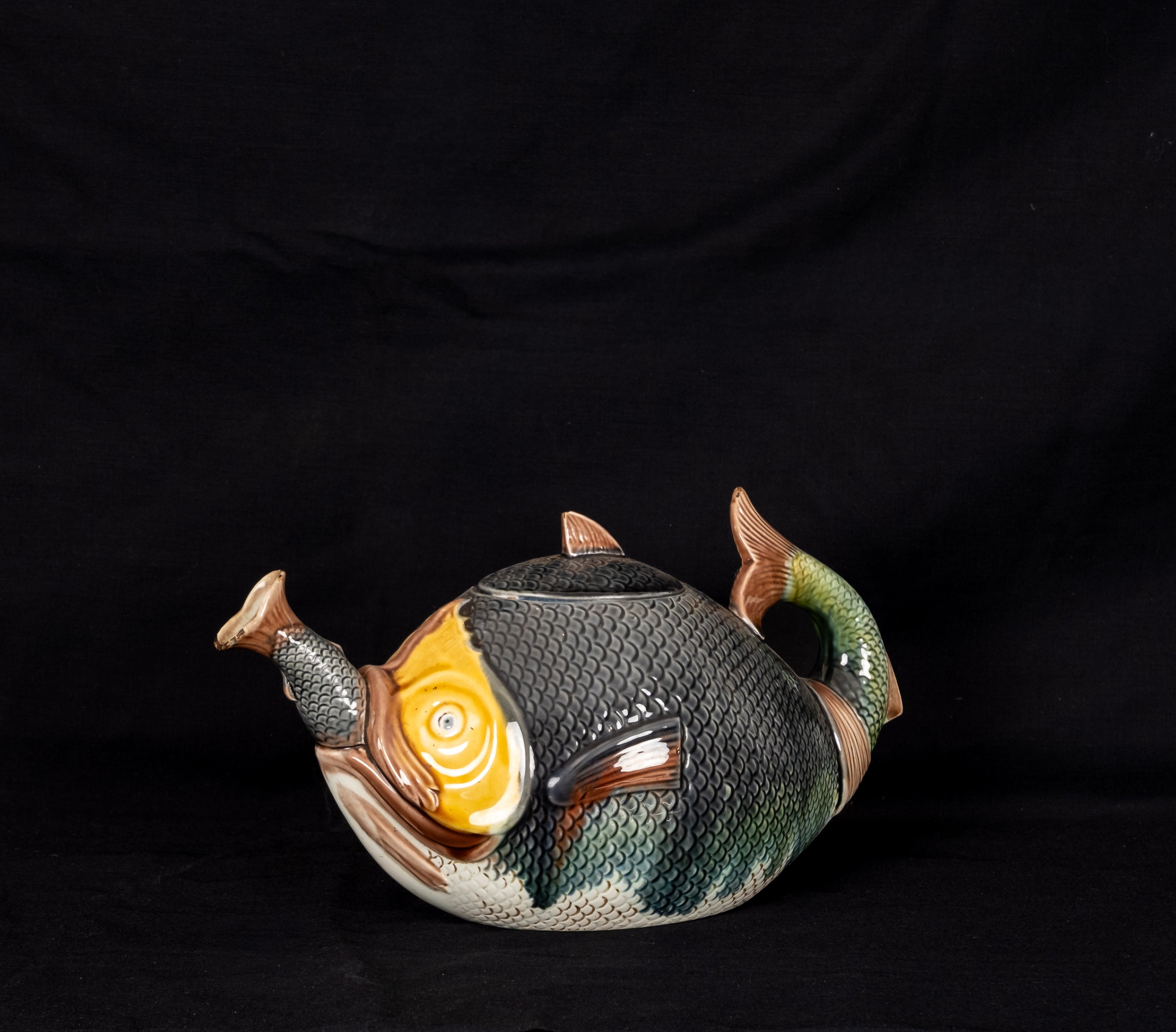 Antique Victorian majolica fish swallowing fish novelty teapot circa 1880 with colourful glazed scales and curled tail handle