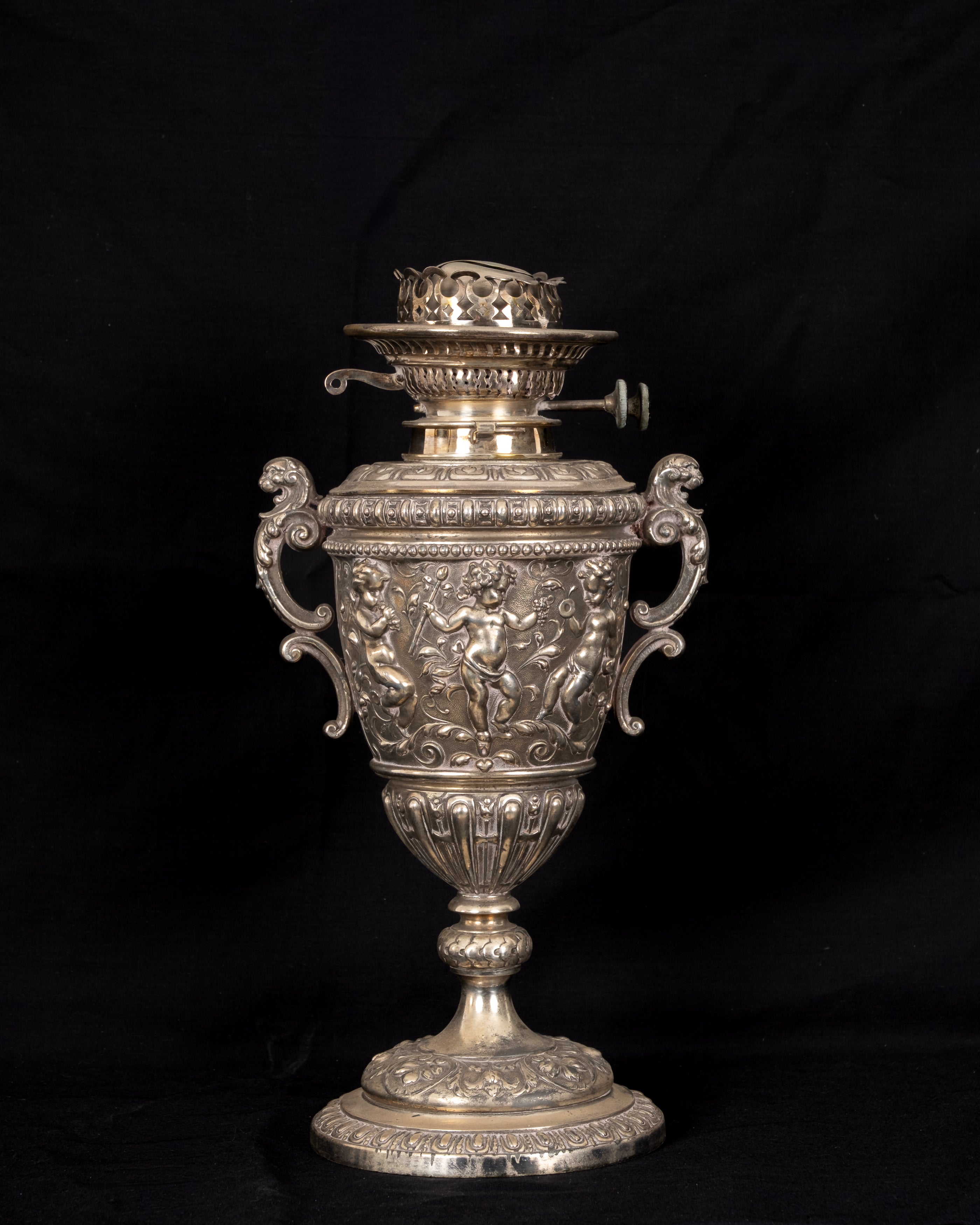 Antique Victorian silver-plated figural duplex oil lamp circa 1890 with classical putti, ornate handles and twin-wick Palmer burner