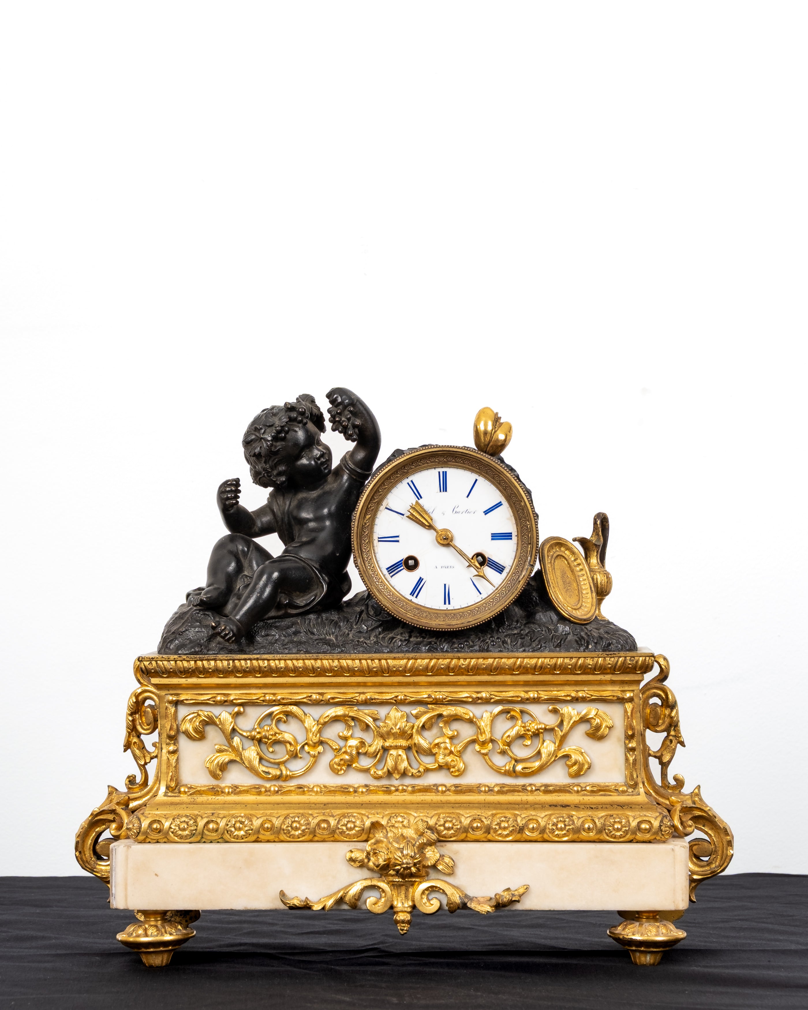 Antique French bronze ormolu and marble figural mantel clock by Siffel and Cartier Paris with Bacchic putto