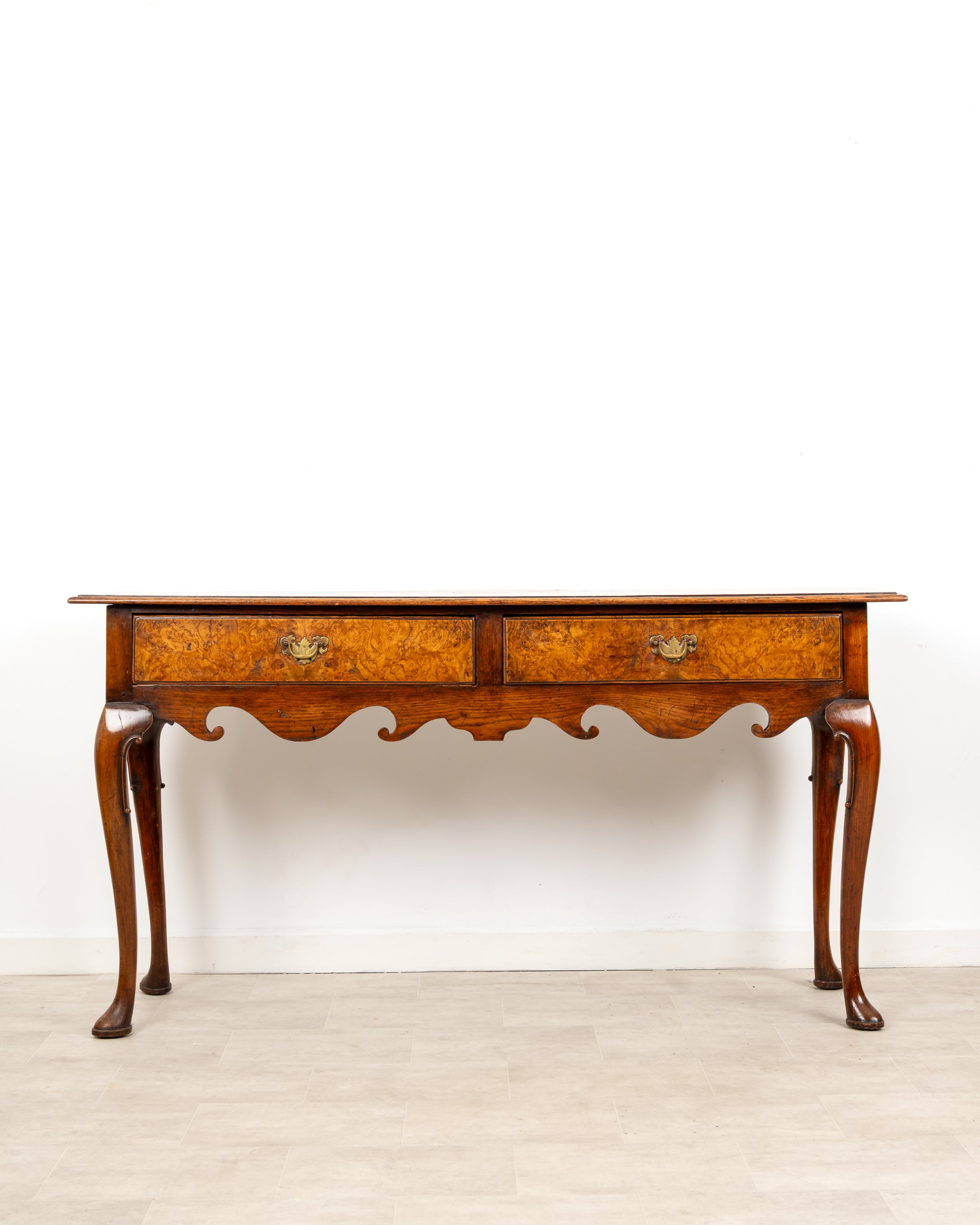 Antique Queen Anne style burr walnut console table with two drawers and cabriole legs circa 1920