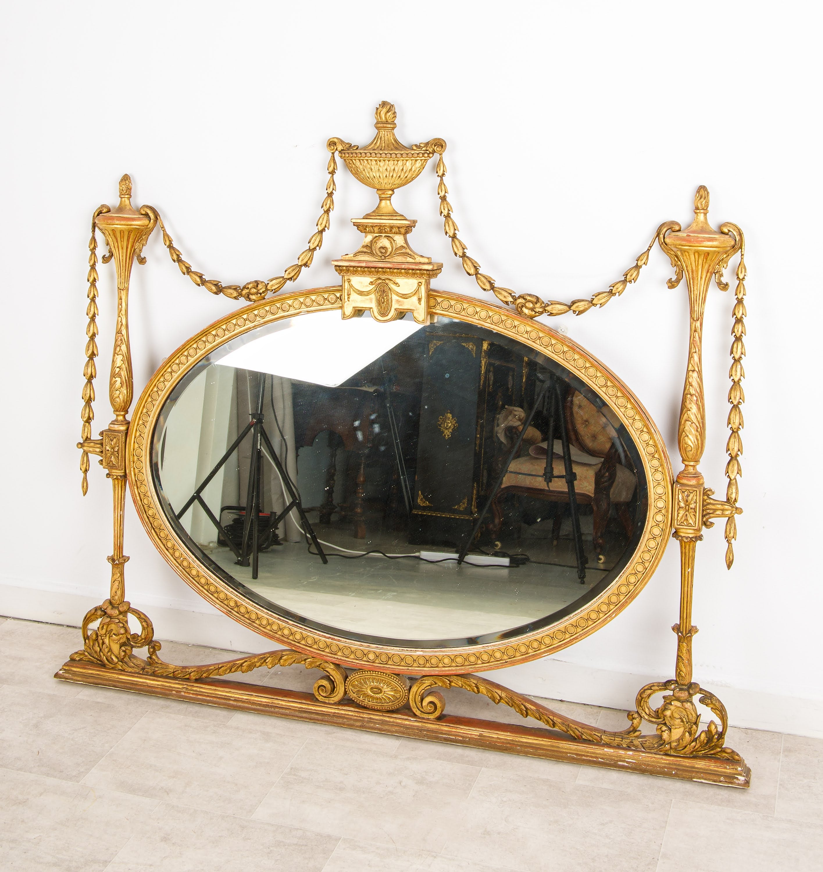 Antique giltwood oval overmantel mirror torchère column and husk swag detail, right side